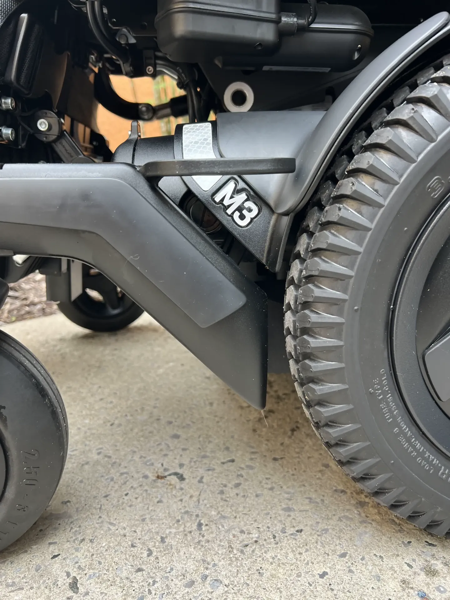 Permobil M3 Corpus drive wheel with clean, unworn tread