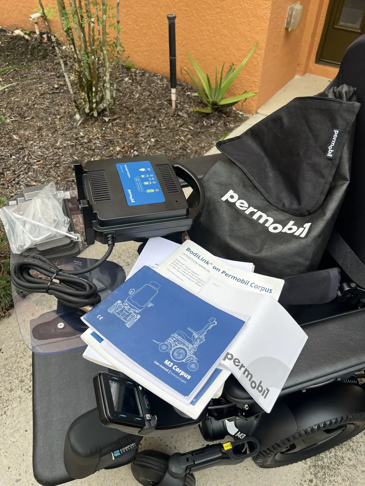 Permobil M3 Corpus power wheelchair with included manuals and documents